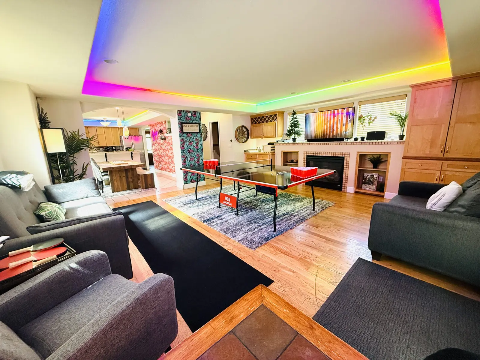 RiNo Party Palace living room with beer pong and rainbow lighting