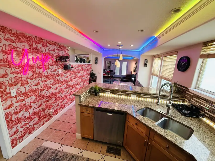 Lounge with pink wall and rainbow ceiling lights