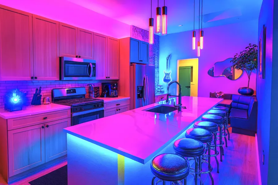Kitchen with bar seating and color lighting
