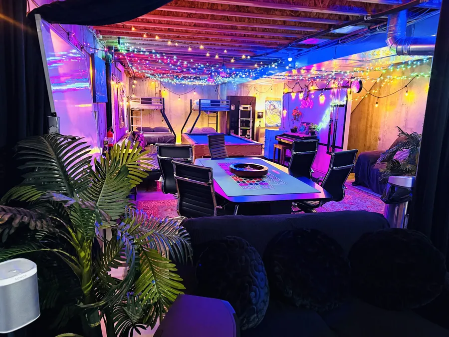 RiNo Compound patio and game area lit up at night